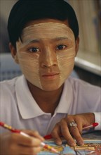 MYANMAR, Children, Single Girls, Young girl wearing thanaka paste on her face in traditional
