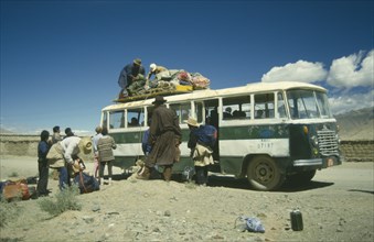TIBET, Tranport, Bus, Bus in the countryside being loaded with goods by passengers
