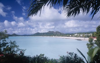WEST INDIES, Antigua, Jolly Beach, View over water towards distant beach and coastline framed by