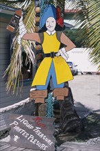WEST INDIES, Antigua, St Johns, Redcliffe Quay.  Cut out pirate figure and sign advertising rum.