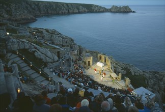 ENGLAND, Cornwall, Minack Theatre, View over audience at evening production in theatre carved out