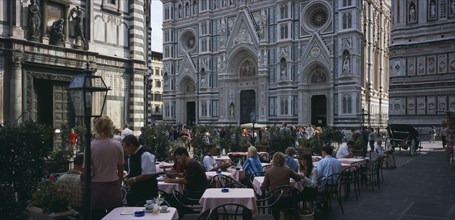 ITALY, Tuscany, Florence, Cafe in front of the Neo-Gothic marble facade of the Duomo with people