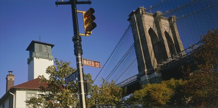 USA, New York State, New York, Part view of Brooklyn Bridge seen above trees with road sign and