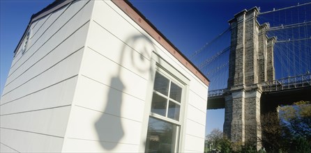 USA, New York , Manhattan, Part view of Brooklyn Bridge with shadow cast by street lamp on exterior