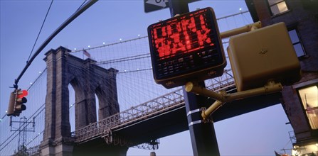 USA, New York, Manhattan, Part view of Brooklyn Bridge at dusk with traffic lights displaying Dont