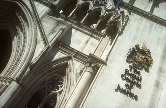 ENGLAND, London, Royal Courts of Justice. View looking up at the building with the crest displayed