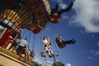 ENTERTAINMENT, Fun-fair, Angled view of children on ride at London funfair.