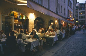 FRANCE, Rhone Loire, Rhone, Lyon.  People eating at outside tables in street side restaurants in