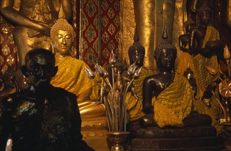 THAILAND, North, Chiang Mai, Wat Chedi Luang. Group of various Buddha statues in the main temple