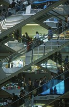 THAILAND, Bangkok, People on escalators inside the MBK Ma Boon Krong Shopping Center