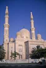 UAE, Dubai, Jumeirah Mosque. Domed building with scattered trees.