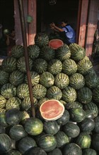 THAILAND, North, Chiang Mai, "Wholesale Food Market.  Large pile of watermelon for sale, woman with