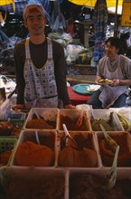 THAILAND, North, Chiang Mai, Wholesale Food Market.  Male vendor behind stall selling  selection of