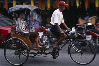 THAILAND, North, Chiang Mai, Cyclo in motion with passenger.