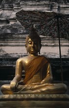THAILAND, North, Chiang Mai, Wat Bupparam Temple on Tha Phae Road. Seated Golden Buddha statue