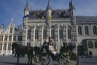 BELGIUM, West Flanders, Bruges, Tourist horse and carriage outside the Stadhuis in Burg Square