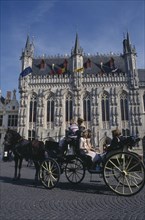BELGIUM, West Flanders, Bruges, Tourist horse and carriage outside the Stadhuis in Burg Square