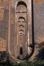 ENGLAND, West Sussex, Haywards Heath, Balcombe. View through line of arches under railway viaduct.
