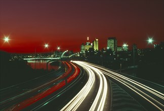AUSTRALIA, Queensland, Brisbane, The south east freeway approaching the city illuminated at night