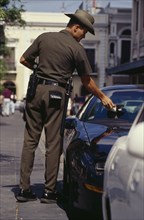 WEST INDIES, Puerto Rico, San Juan, Traffic policeman issuing parking ticket.