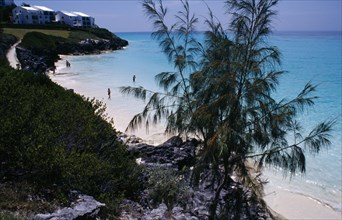 BERMUDA, Whale Bone Bay, View over bay encircled by sandy beach with a few people in the sea.