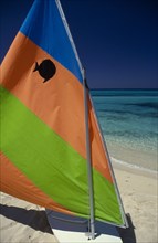 WEST INDIES, Jamaica, Transport, "Sail board with colourful, striped sail pulled up on sandy beach