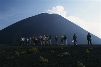 GUATEMALA, Pacaya Volcano, Crater view of the volcano with a line of people looking toward the