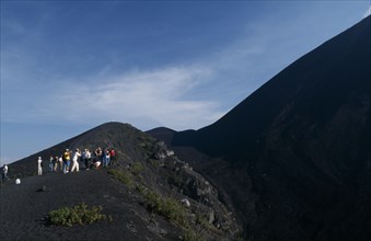 GUATEMALA, Pacaya Volcano, "View of people hiking up an ash path to the summit, stopped to take