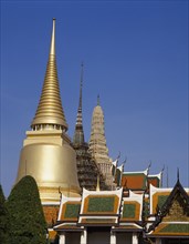 THAILAND, Bangkok, Wat Phra Kaew, Aka the Grand Palace. Colourful rooftops and spires with golden