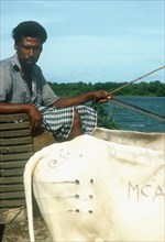 SRI LANKA , China Bay, Local man on ferry with ox cart.  Cropped view of oxen  decorative markings