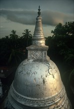 SRI LANKA, Anuradhapura, "Carved Dagoba near Isurumuniya rock temple, damaged surface shining