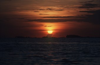 PANAMA, San Blas Islands, Yellow sunset over the low lying islands