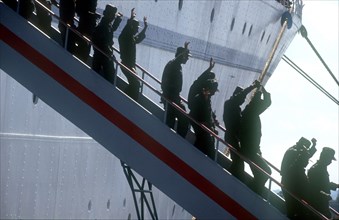CUBA, Military, Waving soldiers returning from Angola walking down the gangway from a ship