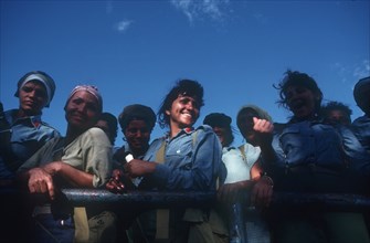 CUBA, Military, Female militia looking over the side of a truck and laughing