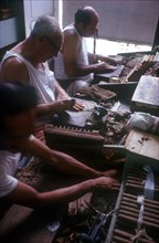 CUBA, Sancti Spiritus, Trinidad, Three men rolling cigars in a small factory