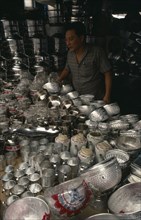 THAILAND, Bangkok, Stall selling chrome / silver kitchen utensils at the weekend market with vendor