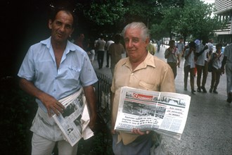 CUBA, Havana, Newspaper vendors standing in the street