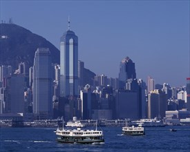 HONG KONG, Victoria Harbour, Star Ferries sailing away from the city skyline behind
