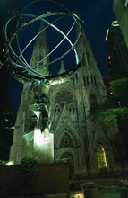 USA, New York, New York City, Atlas and St Patricks Cathedral illuminated at night