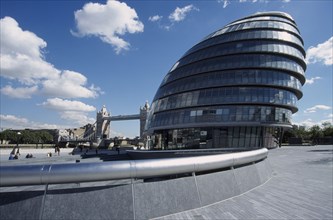 ENGLAND, London, "City Hall, exterior view of the curved architecture with Tower Bridge in the