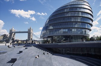 ENGLAND, London, City Hall exterior view of the curved architecture with Tower Bridge in the