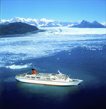 USA, Alaska, Cruise ship below glacier