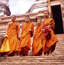 THAILAND, Religion, Buddhist, Four novice monks standing on temple steps