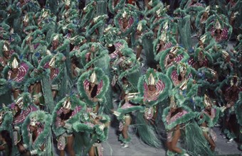 BRAZIL, Rio de Janeiro, Carnival procession of dancers dressed in green feathered costumes