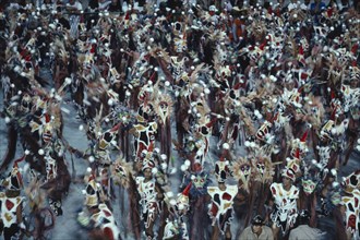 BRAZIL, Rio de Janeiro, Carnival procession of dancers dressed in feathered costumes