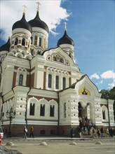 ESTONIA, Tallinn, Alexander Nevsky Cathedral with people sitting on steps at the entrance.