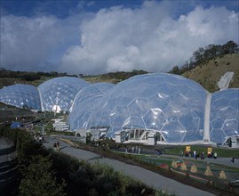 ENGLAND, Cornwall, St Austell, Eden Project. View over temperate domes with tropical domes behind