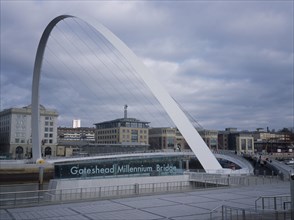 ENGLAND, Tyne and Wear, Gateshead, Millennium Bridge. Large white arch with suspended platform over