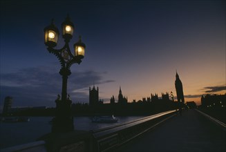 ENGLAND, London, The Houses of Parliament at sunset seen across Westminster Bridge