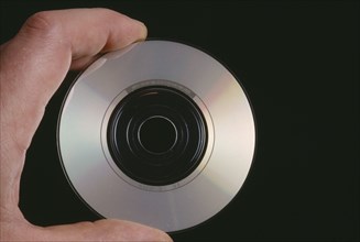 MUSIC, Recorded, Compact Disc, Hand holding a CD single showing the recorded side